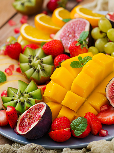 Platter fruits and berries. Mango, kiwi, fig, strawberry, grapes